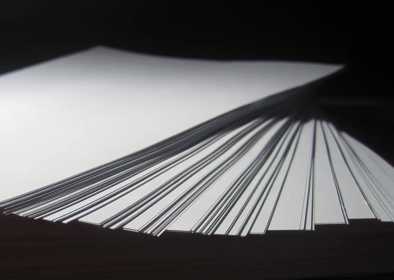 A stack of blank white paper on a desk